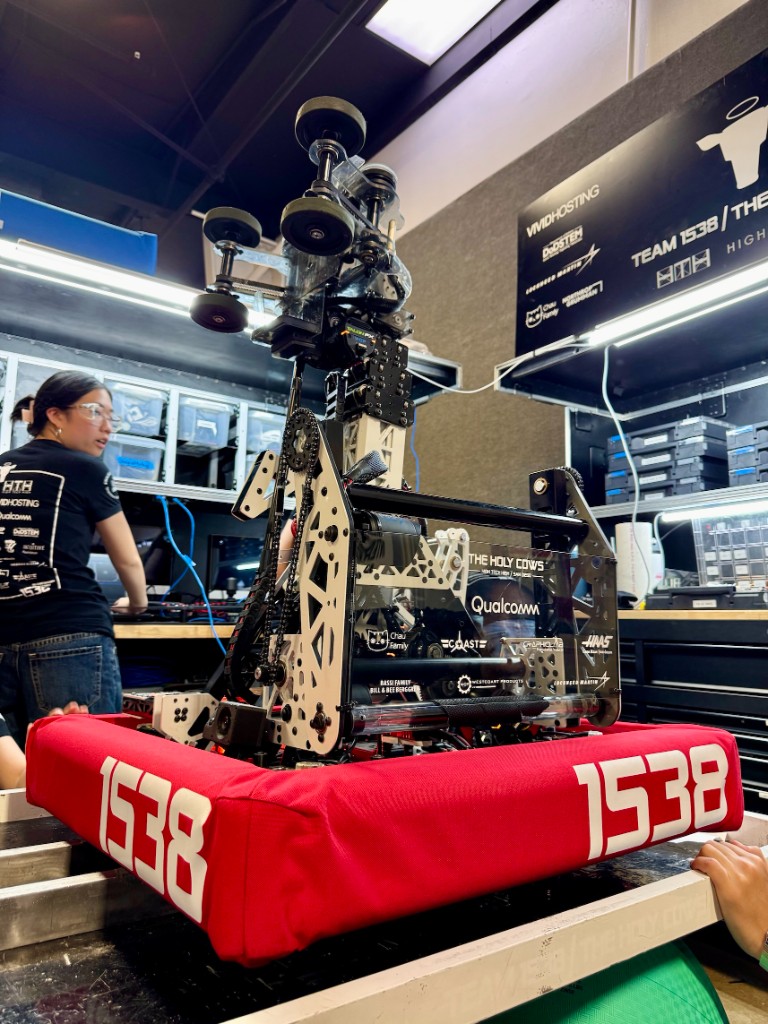 Team 1538 competition robot with red bumpers displaying the team number 1538 in white