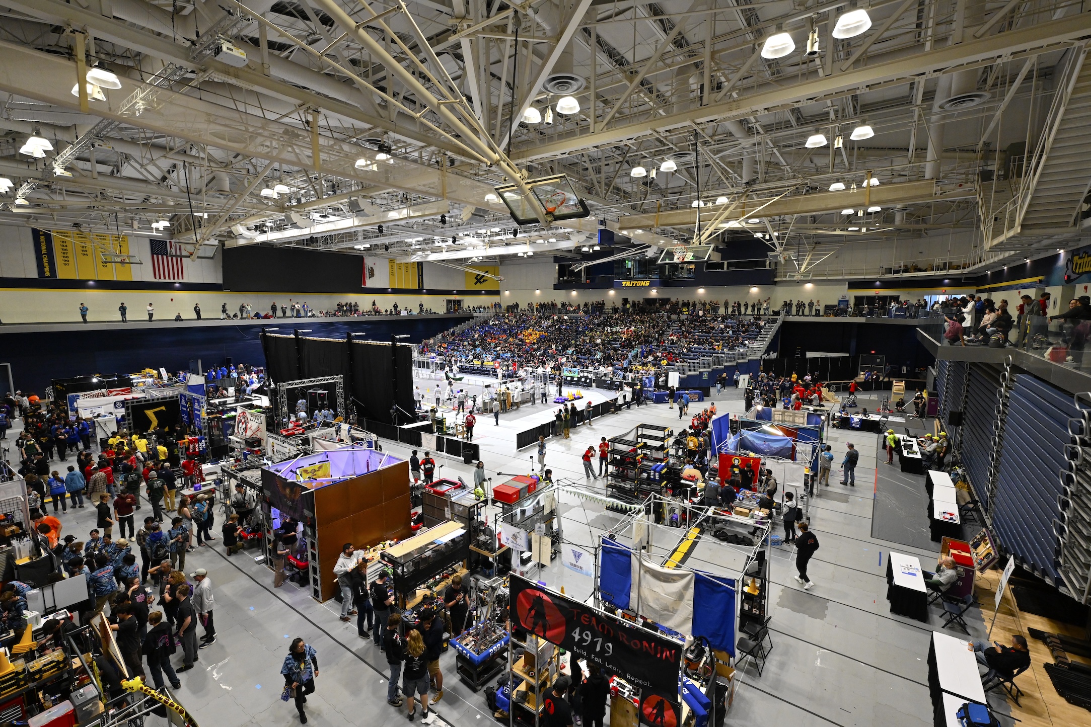 San Diego Regional FIRST Robotics Competition event showing the field and robot pits